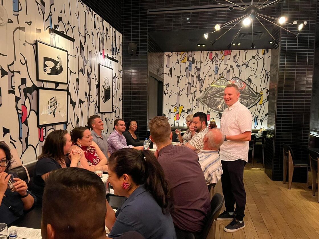 People dining in a modern restaurant with abstract art on the walls.