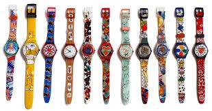 Colorful, patterned wristwatches arranged in a row on a white background.