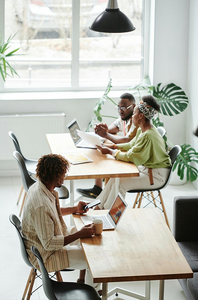 View of workspace with people sitting.